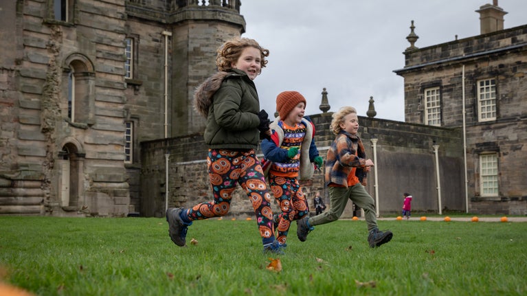 Children playing in October half term in autumn at Seaton Delaval Hall Northumberland
